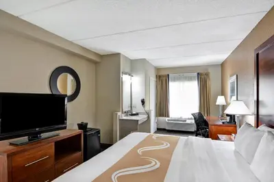 a hotel room with a bed and a flat screen tv at Quality Inn & Suites Heritage Park in Kissimmee