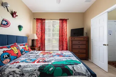 a bedroom with a bed and a television in it at Windsor Hills Resort 2 Miles to Disney 6-Bedroom 4-Bathrooms Villa with Private Pool and Spa in Orlando