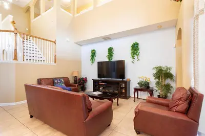 a living room with two couches and a flat screen tv at Windsor Hills Resort 2 Miles to Disney 6-Bedroom 4-Bathrooms Villa with Private Pool and Spa in Orlando
