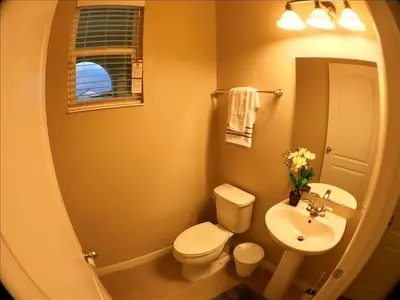 a bathroom with a white toilet and a sink at Four Bedrooms Townhome 5126 in Kissimmee