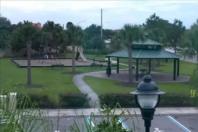 a park with benches and a gazebo at Four Bedrooms Townhome 5126 in Kissimmee