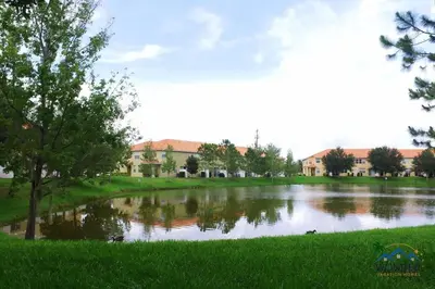 a river with trees and buildings in the background at Four Bedrooms Townhome 5126 in Kissimmee