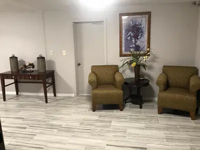 a waiting room with two chairs and a table at Enterprise Motel in Kissimmee