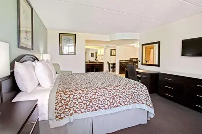 a hotel room with a bed and a desk at Days Inn by Wyndham Orlando Airport Florida Mall in Orlando