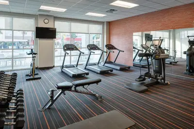 a gym with several tread machines in a room at TownePlace Suites by Marriott Orlando at SeaWorld in Orlando