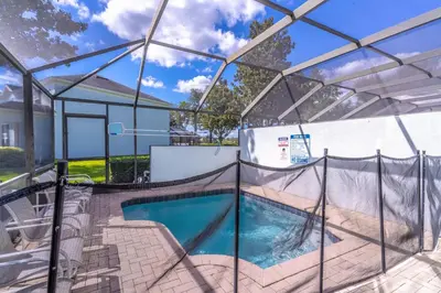 a swimming pool with a glass enclosure at 2582 Windsor Hills in Orlando
