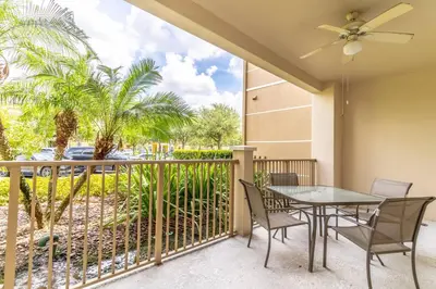 a patio with a table and chairs on a balcony at Viz Cay 4816 in Orlando