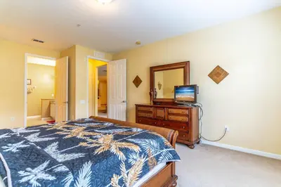 a bedroom with a bed and a television on a dresser at Viz Cay 4816 in Orlando