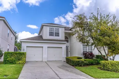 a white house with a garage at 7741 Windsor Hills in Orlando