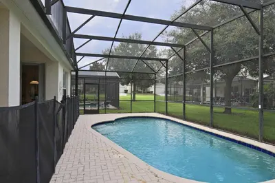a swimming pool inside of a house with a glass roof at 2627 Windsor Hills in Orlando