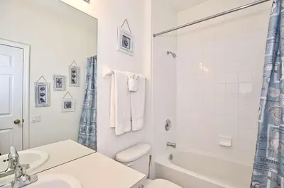 a bathroom with a sink and a toilet and a tub at 2627 Windsor Hills in Orlando