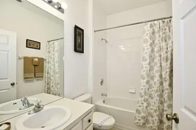 a bathroom with a sink and a toilet and a tub at 2627 Windsor Hills in Orlando