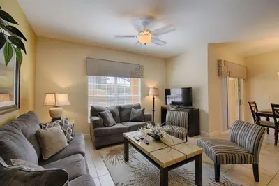 a living room with a couch and a table at 3085 Paradise Palms in Kissimmee