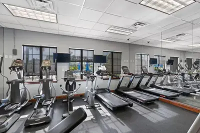 a gym with a row of treadms and cardio machines at 8965 Paradise in Kissimmee