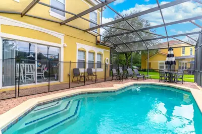 a swimming pool with a pergola next to a house at 3031 Encantada in Kissimmee