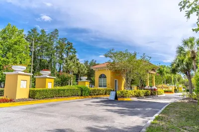 a yellow house with a driveway at 3031 Encantada in Kissimmee