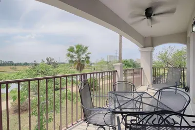 a porch with chairs and tables on a balcony at 5048 Viz Cay in Orlando