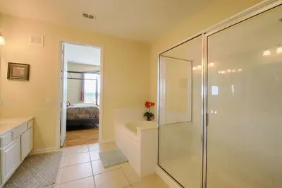 a bathroom with a shower and a toilet and a sink at 5048 Viz Cay in Orlando
