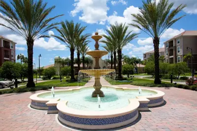 a fountain in a park with palm trees at 5048 Viz Cay in Orlando