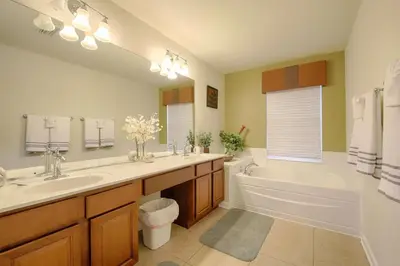 a bathroom with a tub and a sink and a bath tub at 2540 Windsor Hills in Orlando
