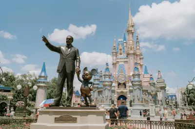 a statue of a man in front of the disney castle at 2540 Windsor Hills in Orlando