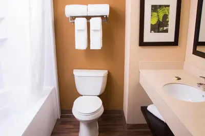 a bathroom with a toilet and a sink at Extended Stay America Select Suites - Orlando - Conven Ctr - Sports Complex in Orlando