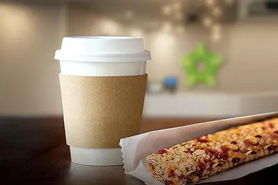 a cup of coffee and a hot dog on a table at Extended Stay America Suites - Orlando - Lake Buena Vista in Orlando
