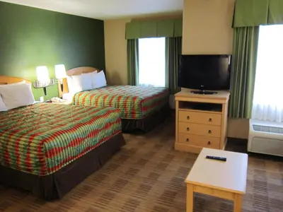 a hotel room with two beds and a flat screen tv at Extended Stay America Suites - Orlando - Lake Buena Vista in Orlando