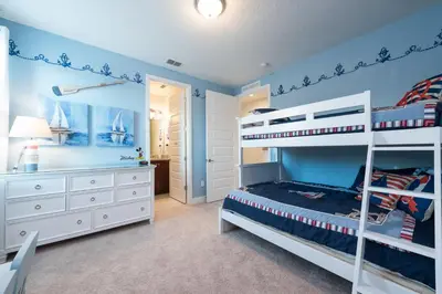 a bedroom with blue walls and a bunk bed at Groovy Mouse House with private pool in Orlando