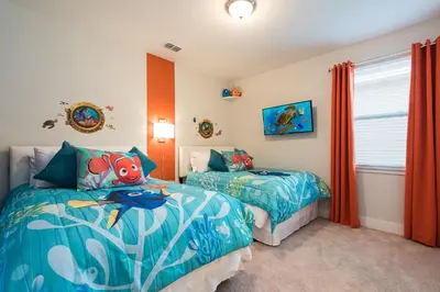 a bedroom with two beds with a fish on them at Groovy Mouse House with private pool in Orlando