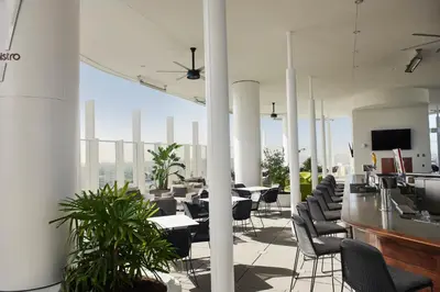 a large room with chairs and tables and a television at Universal's Aventura Hotel in Orlando