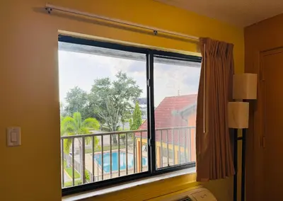 a window with a view of a pool at Budget Inn Of Orlando in Orlando