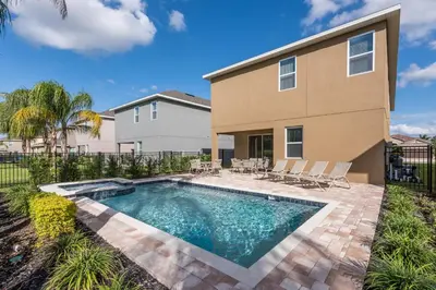 a swimming pool in front of a house at Inviting Home With Private Pool Near Disney With Water Park & Resort Access At Encore Resort - 7498Mr in Kissimmee