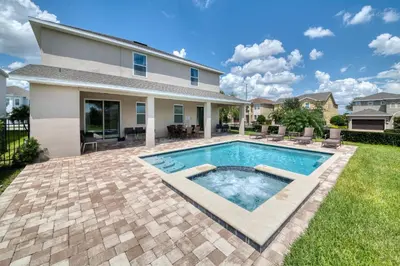 a swimming pool in the backyard of a house at Exquisite Home With Media Room & Games With Waterpark & Resort Access Near Disney At Encore Resort- 7600Mc in Kissimmee