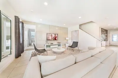 a living room with a large white couch at Exquisite Home With Media Room & Games With Waterpark & Resort Access Near Disney At Encore Resort- 7600Mc in Kissimmee