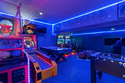 a gaming room with arcade games and pool tables at Beautiful Home With Private Pool, Media & Game Room Near Disney With Waterpark And Resort Access At Encore Resorts Reunion - 210Cl in Kissimmee