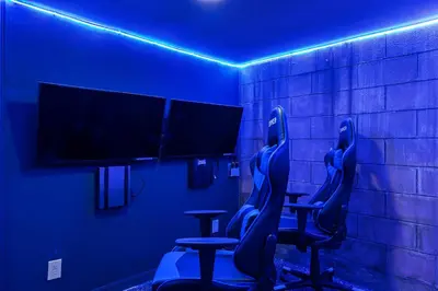a blue room with two chairs and a tv at Beautiful Home With Private Pool, Media & Game Room Near Disney With Waterpark And Resort Access At Encore Resorts Reunion - 210Cl in Kissimmee