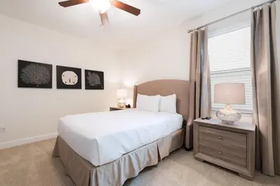 a bedroom with a white bed and a window at Luxury Home Near Disney With Private Pool, Waterpark & Resort Access At Encore Resorts Reunion - 211Mn in Kissimmee