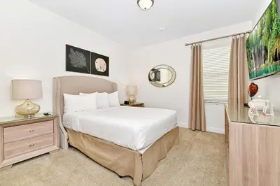 a bedroom with a bed and a dresser and a window at Luxury Home With Themed Rooms, Game Room And Waterpark & Resort Access Near Disney At Encore Resorts Reunion - 260Cl in Kissimmee