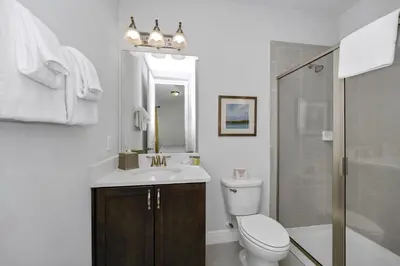 a bathroom with a toilet and a sink and a shower at Vibrant Elite Home With Private Pool, Theater Room And Waterpark & Resort Access Near Disney At Encore Resort - 7605Mc in Kissimmee