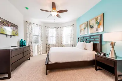 a bedroom with a bed and a ceiling fan at Vibrant Elite Home With Theater Room And Waterpark & Resort Access Near Disney At Encore Resort - 7603Mc in Orlando