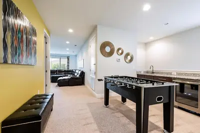 a living room with a stove in the middle of a room at Vibrant Elite Home With Theater Room And Waterpark & Resort Access Near Disney At Encore Resort - 7603Mc in Orlando