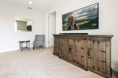 a living room with a flat screen tv on a wall at Modern Home Near Disney With Private Pool, Media Room And Waterpark & Resort Access At Encore Resorts Reunion - 7576Mr in Kissimmee