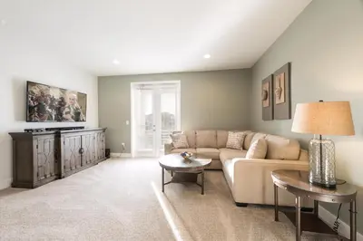 a living room with a couch and a table at Modern Home Near Disney With Private Pool, Media Room And Waterpark & Resort Access At Encore Resorts Reunion - 7576Mr in Kissimmee