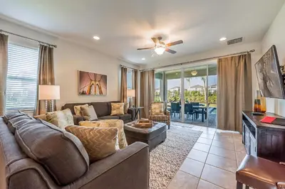 a living room with a couch and a table at Elegant Home Near Disney With Private Pool And Waterpark & Resort Access At Encore Resorts Reunion - 391Fl in Kissimmee