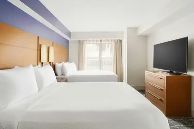 a hotel room with two beds and a flat screen tv at Residence Inn Orlando Lake Buena Vista in Orlando