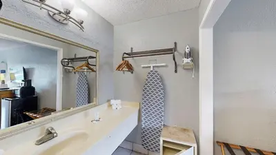 a bathroom with a sink and a mirror at Days Inn by Wyndham Orlando Downtown in Orlando