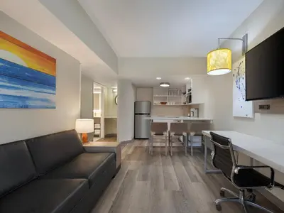 a living room with a couch and a dining room at Holiday Inn Resort Orlando Suites - Waterpark by IHG in Orlando