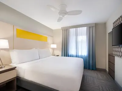 a bedroom with a large white bed and a window at Holiday Inn Resort Orlando Suites - Waterpark by IHG in Orlando