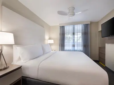a bedroom with a white bed and a window at Holiday Inn Resort Orlando Suites - Waterpark by IHG in Orlando